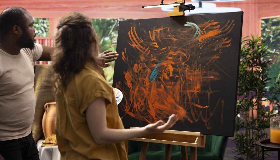 Team of artists in a gallery atelier working on a new art piece, using the finger painting technique for an abstract creation. Blending acrylic paints with precision to create a contemporary design.
